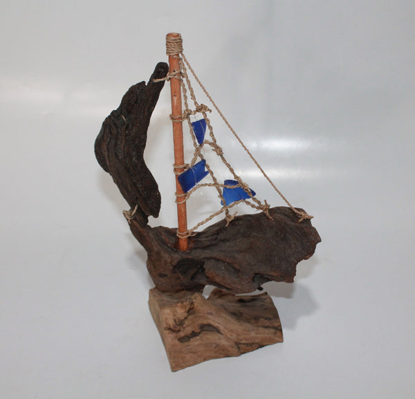 Driftwood Boat with Blue Sail