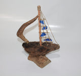 Driftwood Boat with Blue Sail