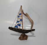 Driftwood Boat with Blue Sail