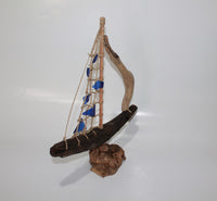 Driftwood Boat with Blue Sail