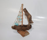 Driftwood Boat with Light Blue Sail