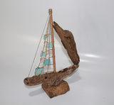 Driftwood Boat with Light Blue Sail