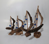 Driftwood Boat with Blue Sail