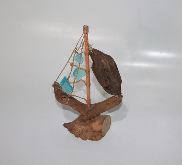 Driftwood Boat with Light Blue Sail
